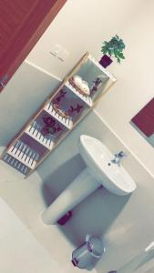 a bathroom with a white sink and a mirror at Unique Home in Yanbu