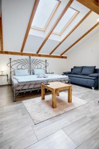 a living room with a bed and a coffee table at Apartmány Svatošské skály in Loket