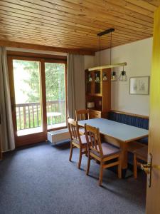 a dining room with a table and two chairs at Mai-Brunn Alm Appartements, Maibrunnenweg 34-36 in Bad Kleinkirchheim