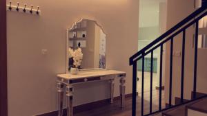 a dressing table with a mirror on a staircase at Unique Home in Yanbu