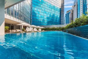 
a large swimming pool in the middle of a city at Ascott Bonifacio Global City Manila in Manila
