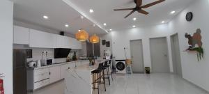 a kitchen with white cabinets and a ceiling fan at D'Homestay Adelia Residence Bangi Avenue in Kajang
