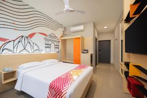 a bedroom with a large bed and a tv at Ginger East Delhi in New Delhi