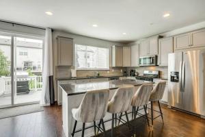a kitchen with a island with bar stools at Stunning four-bedroom town home in Millersville