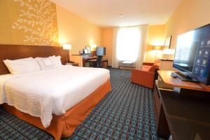 a hotel room with a bed and a flat screen tv at Fairfield Inn & Suites by Marriott Chincoteague Island Waterfront in Chincoteague