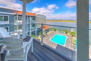 a balcony with a view of the ocean and a swimming pool at Fairfield Inn & Suites by Marriott Chincoteague Island Waterfront in Chincoteague