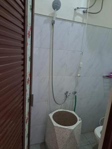a bathroom with a shower with a toilet in it at Omah Medina in Klaten