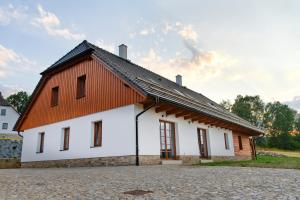 a large white building with a red roof at Chalupa Pod Šerovnou 