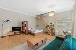 a living room with a couch and a tv at Arbio I 1A Rooms & Apartments Prenzlauerberg Berlin in Berlin