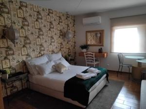 a bedroom with a bed with two towels on it at Casa Aldeia da Lapa in Sernancelhe