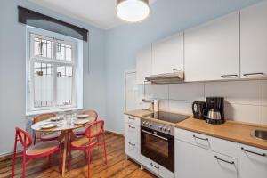 a kitchen with a table and chairs and a small table with a table at Arbio I 1A Rooms & Apartments Prenzlauerberg Berlin in Berlin