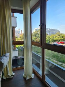 a room with a window looking out at the city at VENICE VILLA Apartment, self check-in 24h, free parking in Poznań