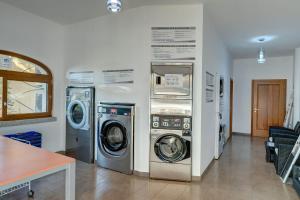 two washing machines and a washer and dryer in a room at The fantastic Residenza Badus-1 bedroom Apartment sleeps 4 -SeaView-No0814 in Badesi