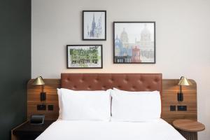 a bedroom with a bed with three pictures on the wall at Four Points by Sheraton Edinburgh in Edinburgh +74 photos