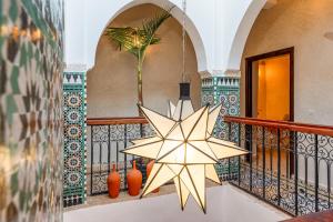 a star chandelier on a staircase in a house at Riad Privé Dar L'Étoile - Piscine & Petit Déj inclus in Marrakesh