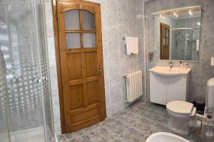 a bathroom with a toilet and a sink and a shower at Vila Tequila Sinaia in Sinaia