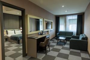 a hotel room with a bed and a desk at Tryp By Wyndham Istanbul Sancaktepe in Istanbul