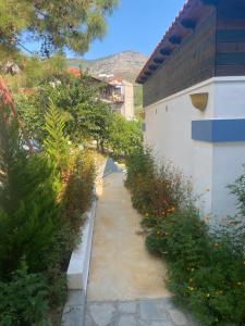 a walkway with flowers next to a building at Blue Bay Beach Hotel in Koinyra