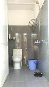 a bathroom with a toilet and a shower in it at Phu Nam House - Resort in Phú Quốc