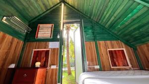 a bedroom with a green ceiling and a bed in a room at Phu Nam House - Resort in Phú Quốc