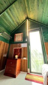 a room with a bed and a window in a room at Phu Nam House - Resort in Phú Quốc