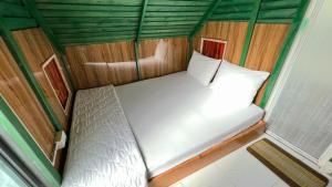 a small bedroom with a white bed in a tent at Phu Nam House - Resort in Phú Quốc