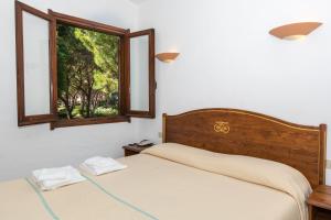 Ένα ή περισσότερα κρεβάτια σε δωμάτιο στο Residence Baia delle Palme Unit 1-Studio