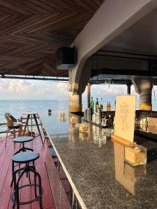 a bar with a view of the ocean at Adarin Beach Resort in Mae Nam