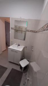a bathroom with a sink and a toilet and a mirror at AbumaHouse in Los Llanos de Aridane +16 photos