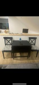 a black table and two chairs in a room at Island View Apartment in Droíchead an Chláir