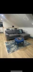 a living room with a couch and a blue coffee table at Island View Apartment in Droíchead an Chláir