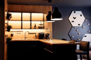 a kitchen with a sink and a counter top with a clock on the wall at Apartmán Volavka in Hlinsko