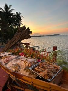 a tray of food on a table next to the water at Adarin Beach Resort in Mae Nam +18 photos