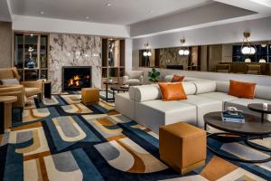 a living room with a couch and a fireplace at Le Centre Sheraton Montreal Hotel in Montreal