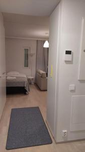 a room with a room with a bed and a couch at Top location studio in town right next to the train station and free parking Kotimaailma Apartments in Jyväskylä