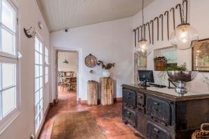 an old dresser in a room with a dining room at Rabaçal Nature Spot Cottage in Estreito da Calheta