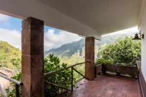 a balcony with a view of the mountains at Rabaçal Nature Spot Cottage in Estreito da Calheta