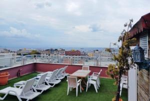 a patio with chairs and a table on a roof at Hotel Süreyya in Istanbul