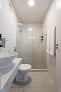 a bathroom with a sink and a toilet and a shower at STUDIOS URCA na rua da mureta da Urca in Rio de Janeiro