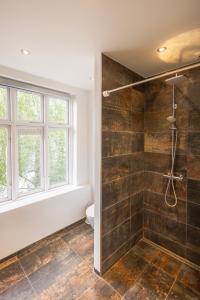ein Bad mit einer Dusche und einem WC in der Unterkunft Central Lyngby Apartments in Kongens Lyngby