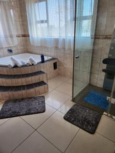 a bathroom with a shower and a bath tub at AGASTEV GUESTHOUSE in Springs