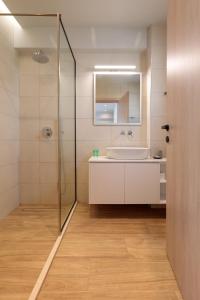 a bathroom with a sink and a glass shower at Marsane Luxury Appartments in Faliraki