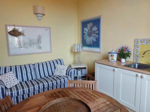 a living room with a couch and a table at Appartamento Mare Blu in Cavo