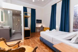 a hotel room with a bed and a bathroom at Villa Clio, a Luxury Collection in Thessaloniki