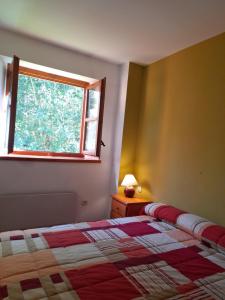 a bedroom with a bed and a window at Ambiente de montaña- Chimenea, vistas y jardín- Isard 4 in Pla de l'Ermita +24 photos