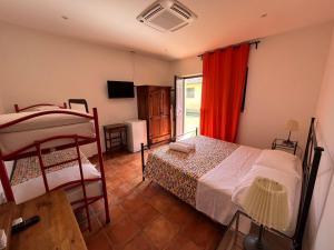 泰拉奇納的住宿－Agriturismo Le Folaghe，一间卧室设有两张双层床和一扇窗户。