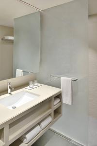 a bathroom with a sink and a mirror at Fairfield by Marriott Hyderabad Gachibowli in Hyderabad