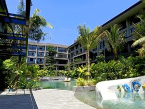 a resort with a swimming pool in front of a building at Anagata Hotels and Resorts Tanjung Benoa in Nusa Dua