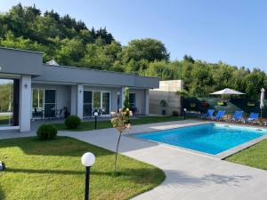 a house with a swimming pool in a yard at Villa Dimo Topal Luxury Suites with Pool & Jacuzzi in Ohrid