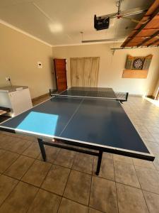 a ping pong table in the middle of a room at Elements golf reserve in Bela-Bela